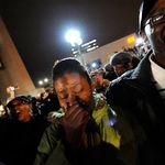 A woman is overwhelmed with news of Obama's victory in Harlem